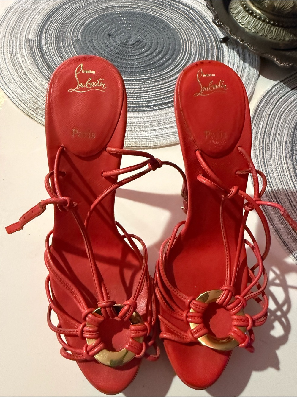 Christian Louboutin Red Strappy Leather Heels with Gold Ring Detail .